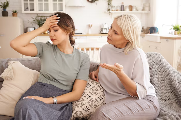 Woman comforting her friend while sitting on the sofa